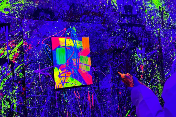 a colorful butterfly on a stage in front of a forest